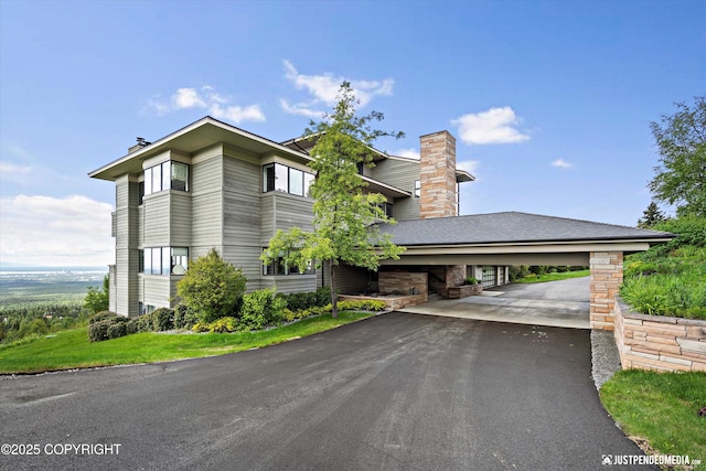 9900 Hillhaven Cir, Anchorage, AK 99507 - view of home's exterior with a chimney, asphalt driveway, and stone siding