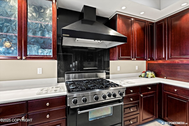 9900 Hillhaven Cir, Anchorage, AK 99507 - kitchen with stainless steel stove, wall chimney range hood, dark brown cabinets, light countertops, and recessed lighting