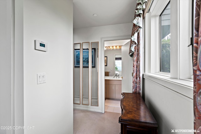 9900 Hillhaven Cir, Anchorage, AK 99507 - hall with light colored carpet and a sink