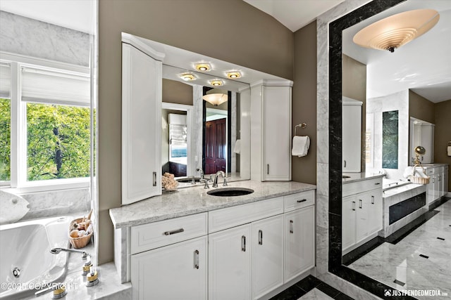 9900 Hillhaven Cir, Anchorage, AK 99507 - full bathroom featuring marble tiled floors, vanity, and a tub with jets