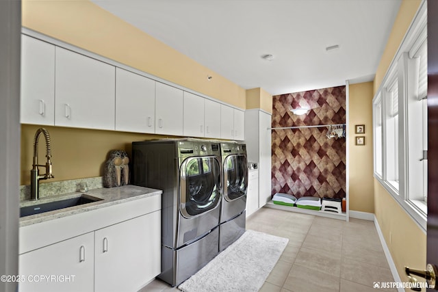 9900 Hillhaven Cir, Anchorage, AK 99507 - laundry area featuring washing machine and clothes dryer, cabinet space, and light tile patterned flooring