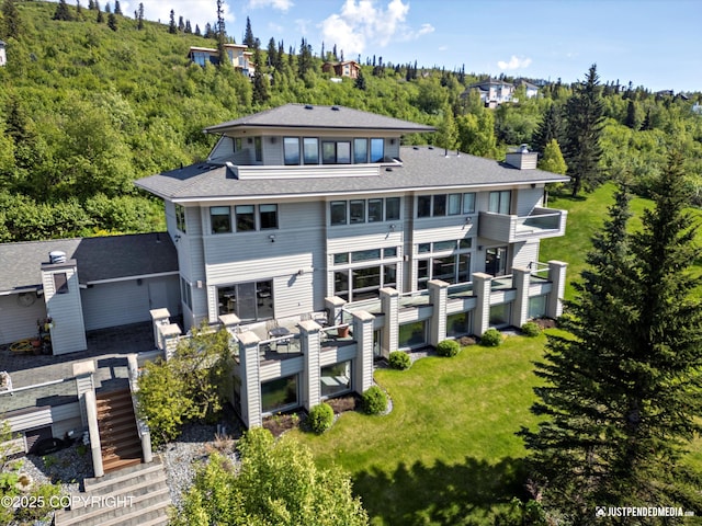 9900 Hillhaven Cir, Anchorage, AK 99507 - rear view of property with a chimney, a forest view, and stairway
