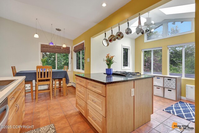 3868 Shannon Cir, Anchorage, AK 99508 - kitchen featuring plenty of natural light, a skylight, light tile patterned floors, light brown cabinets, and recessed lighting
