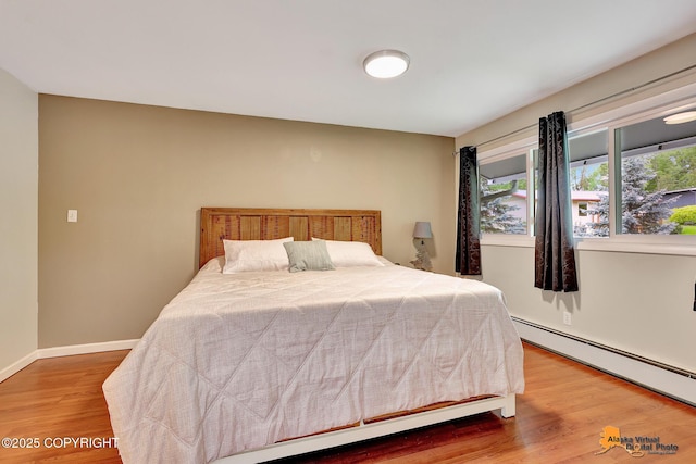 3868 Shannon Cir, Anchorage, AK 99508 - bedroom featuring baseboard heating and wood finished floors