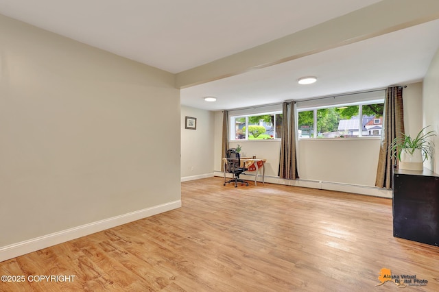 3868 Shannon Cir, Anchorage, AK 99508 - unfurnished room with a baseboard radiator, light wood-style flooring, baseboards, and an office area