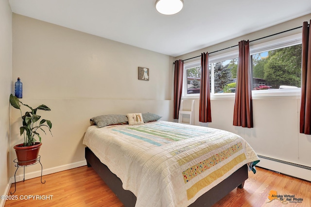 3868 Shannon Cir, Anchorage, AK 99508 - bedroom with a baseboard heating unit, wood finished floors, and baseboards