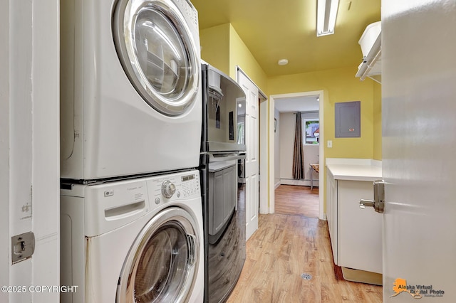 3868 Shannon Cir, Anchorage, AK 99508 - laundry room featuring stacked washer and clothes dryer, light wood-style flooring, and electric panel