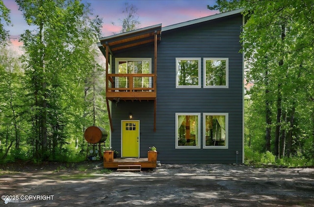 23069 Christiansen Lake Rd, Talkeetna, AK 99676 - back of house at dusk featuring a balcony