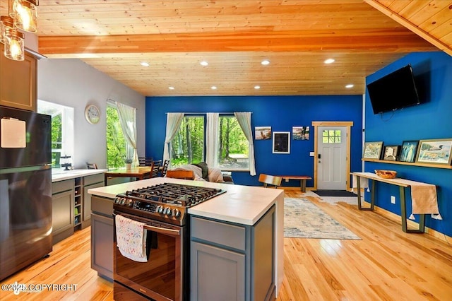 23069 Christiansen Lake Rd, Talkeetna, AK 99676 - kitchen with freestanding refrigerator, gas stove, gray cabinets, wood ceiling, and light countertops