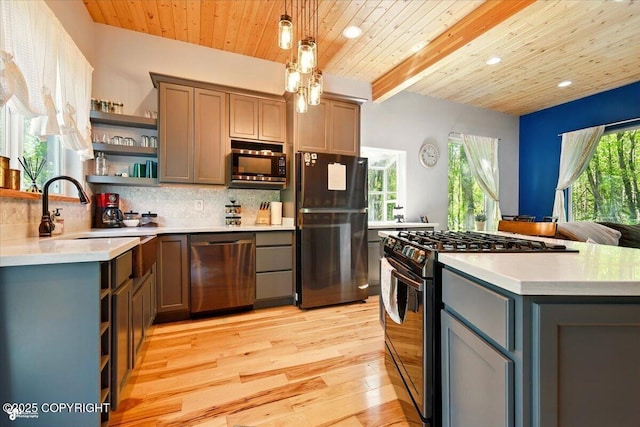 23069 Christiansen Lake Rd, Talkeetna, AK 99676 - kitchen featuring stainless steel appliances, open shelves, gray cabinetry, light wood-style floors, and decorative backsplash