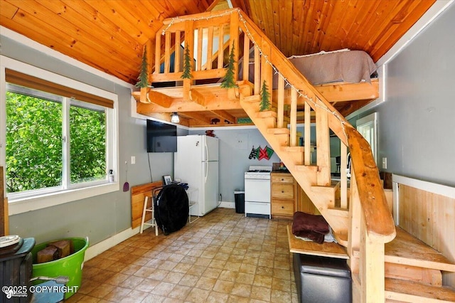 23069 Christiansen Lake Rd, Talkeetna, AK 99676 - basement with wood ceiling, freestanding refrigerator, stairs, and light stone finish floors