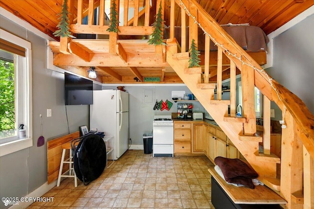23069 Christiansen Lake Rd, Talkeetna, AK 99676 - kitchen with white appliances, wood ceiling, and light stone finish flooring