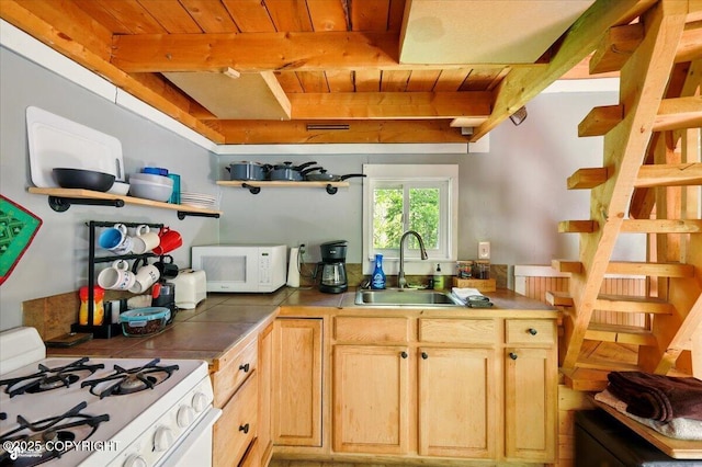 23069 Christiansen Lake Rd, Talkeetna, AK 99676 - kitchen with white appliances, tile countertops, a wooden ceiling with exposed beams, open shelves, and light brown cabinets