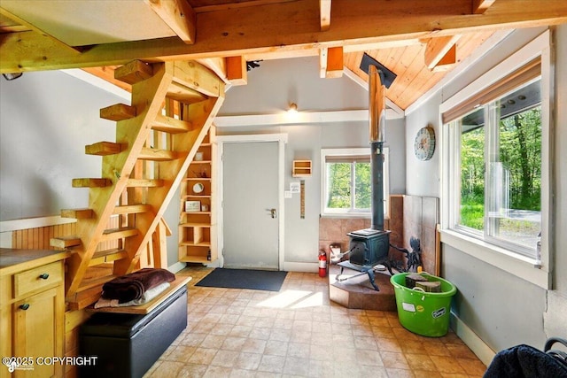 23069 Christiansen Lake Rd, Talkeetna, AK 99676 - foyer entrance featuring a wood stove, stone finish flooring, and stairs