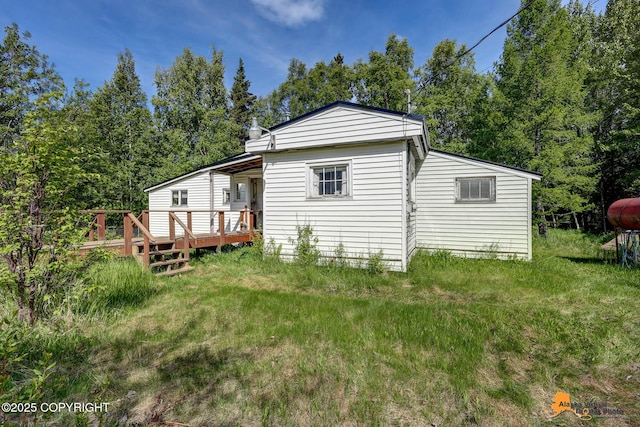 3151 E 151st Ave, Anchorage, AK 99516 - back of property with a wooden deck, a yard, and heating fuel