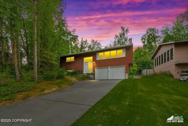 3750 Winterset Dr, Anchorage, AK 99508 - bi-level home featuring a chimney, concrete driveway, a garage, and a front lawn