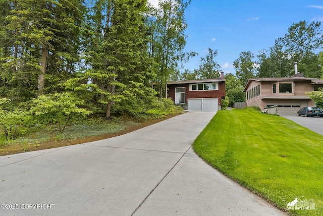 3750 Winterset Dr, Anchorage, AK 99508 - split foyer home featuring an attached garage, concrete driveway, and a front yard