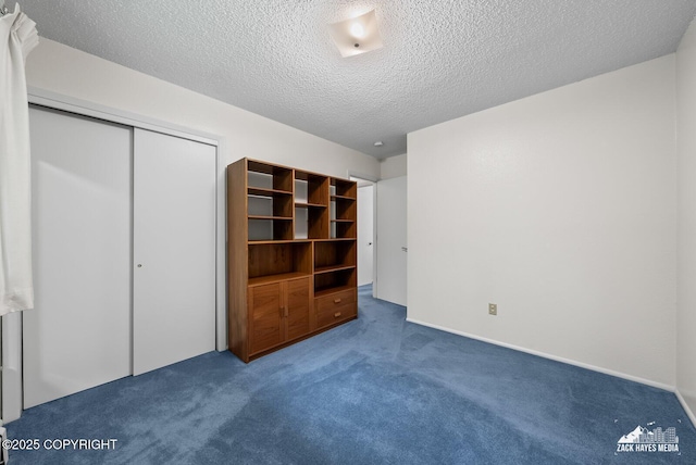 3750 Winterset Dr, Anchorage, AK 99508 - unfurnished bedroom with carpet, a closet, and a textured ceiling