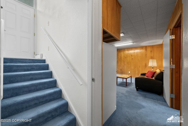 3750 Winterset Dr, Anchorage, AK 99508 - stairway featuring carpet floors and wood walls