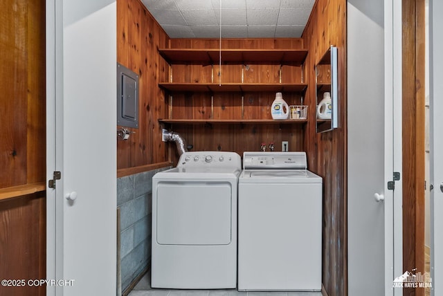3750 Winterset Dr, Anchorage, AK 99508 - washroom with electric panel, washing machine and clothes dryer, and wooden walls