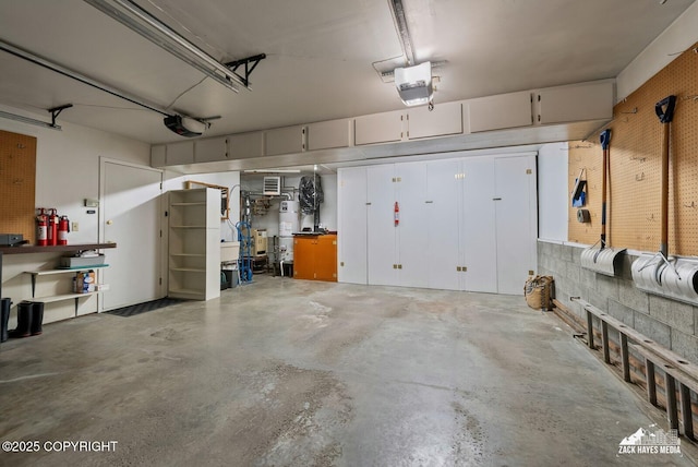 3750 Winterset Dr, Anchorage, AK 99508 - garage featuring a workshop area and a garage door opener