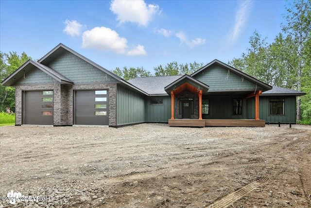 2551 N Earl Dr, Wasilla, AK 99654 - view of front facade featuring a garage, driveway, a porch, and board and batten siding