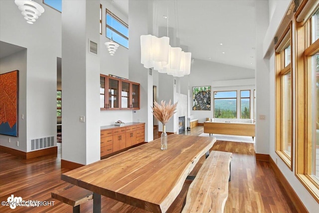 10500 Blackwolf Cir, Anchorage, AK 99507 - dining space with high vaulted ceiling, wood finished floors, and a chandelier