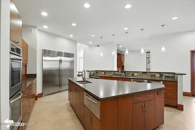 10500 Blackwolf Cir, Anchorage, AK 99507 - kitchen with stainless steel appliances, a large island, a warming drawer, dark countertops, and recessed lighting