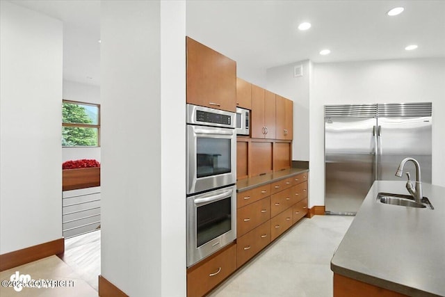 10500 Blackwolf Cir, Anchorage, AK 99507 - kitchen featuring stainless steel appliances, brown cabinetry, and recessed lighting