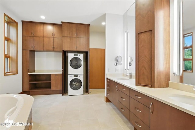 10500 Blackwolf Cir, Anchorage, AK 99507 - bathroom featuring estacked washer and dryer, double vanity, a bath, and recessed lighting