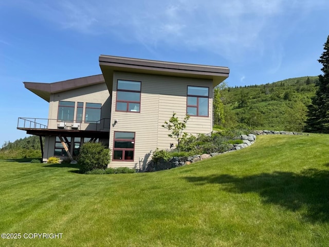 10500 Blackwolf Cir, Anchorage, AK 99507 - back of property featuring a lawn and a wooden deck