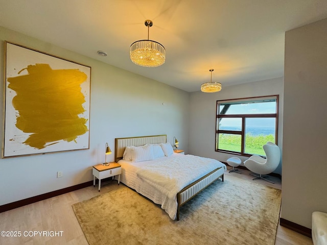 10500 Blackwolf Cir, Anchorage, AK 99507 - bedroom with wood finished floors and a chandelier