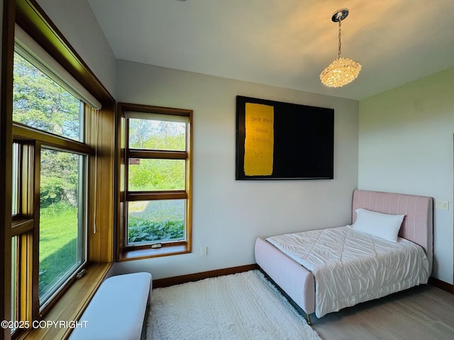 10500 Blackwolf Cir, Anchorage, AK 99507 - bedroom featuring baseboards and a chandelier