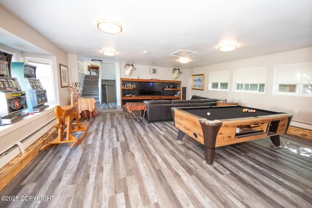 4530 Macalister Dr, Anchorage, AK 99502 - recreation room with wood finished floors, billiards table, plenty of natural light, and a baseboard radiator