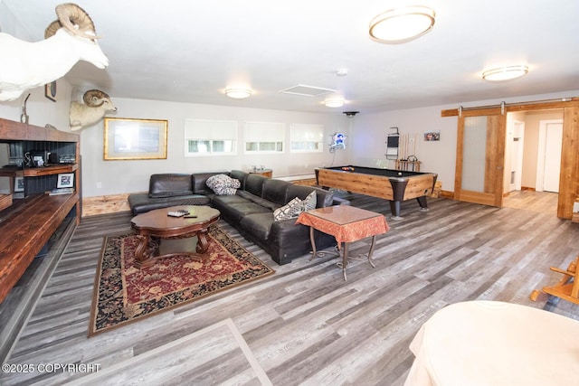 4530 Macalister Dr, Anchorage, AK 99502 - living room with wood finished floors, a barn door, billiards table, and baseboards