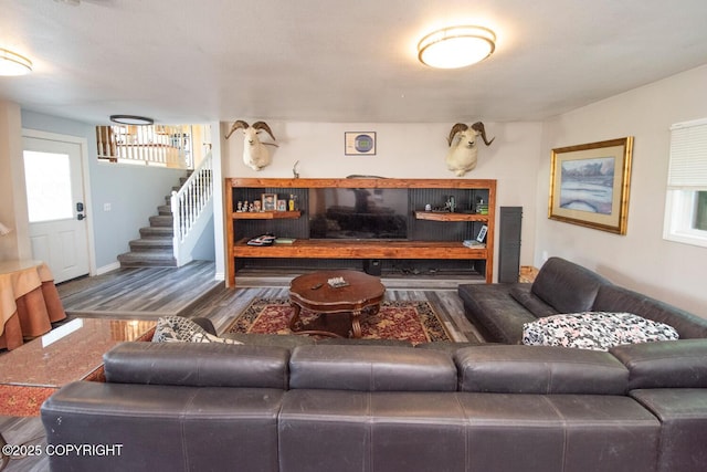 4530 Macalister Dr, Anchorage, AK 99502 - living area featuring baseboards, stairway, and wood finished floors