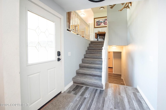 4530 Macalister Dr, Anchorage, AK 99502 - foyer with stairs, wood finished floors, healthy amount of natural light, and baseboards