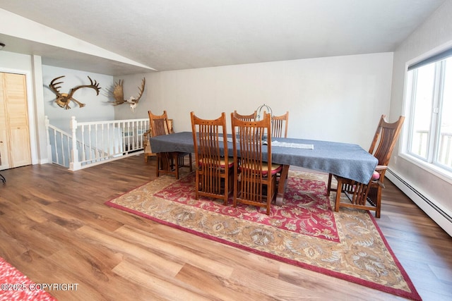 4530 Macalister Dr, Anchorage, AK 99502 - dining area with wood finished floors, a baseboard radiator, and vaulted ceiling