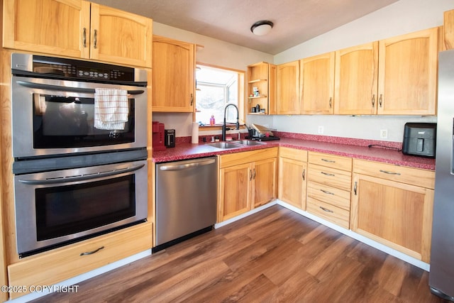 4530 Macalister Dr, Anchorage, AK 99502 - kitchen featuring stainless steel appliances, a sink, light brown cabinetry, dark wood-type flooring, and lofted ceiling