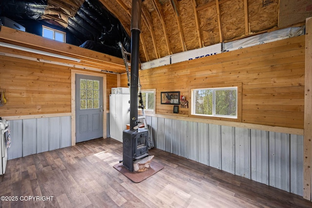 6360 Haystack Dr, Fairbanks, AK 99712 - kitchen featuring a wood stove, wood walls, wood finished floors, and stainless steel range