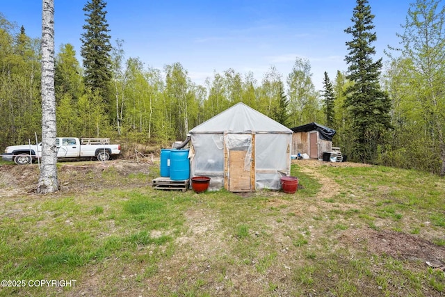6360 Haystack Dr, Fairbanks, AK 99712 - view of yard featuring a greenhouse and an outdoor structure