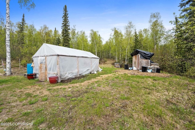 6360 Haystack Dr, Fairbanks, AK 99712 - view of yard featuring an outdoor structure and a forest view