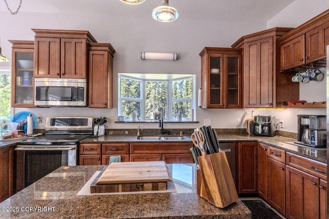 33426 Mid River Ave, Soldotna, AK 99669 - kitchen featuring stainless steel appliances, healthy amount of natural light, and glass insert cabinets