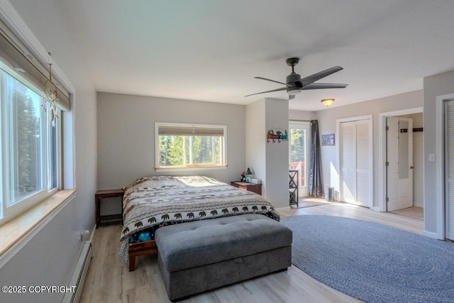 33426 Mid River Ave, Soldotna, AK 99669 - bedroom featuring wood finished floors, a baseboard radiator, and a ceiling fan