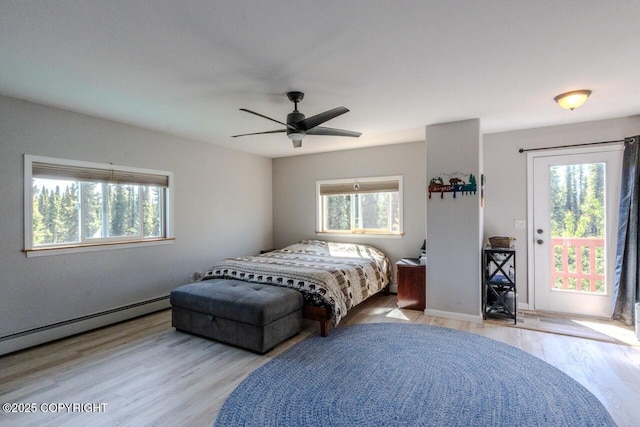 33426 Mid River Ave, Soldotna, AK 99669 - bedroom featuring multiple windows, access to exterior, and wood finished floors