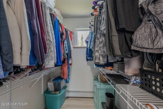 33426 Mid River Ave, Soldotna, AK 99669 - walk in closet with a baseboard radiator and wood finished floors