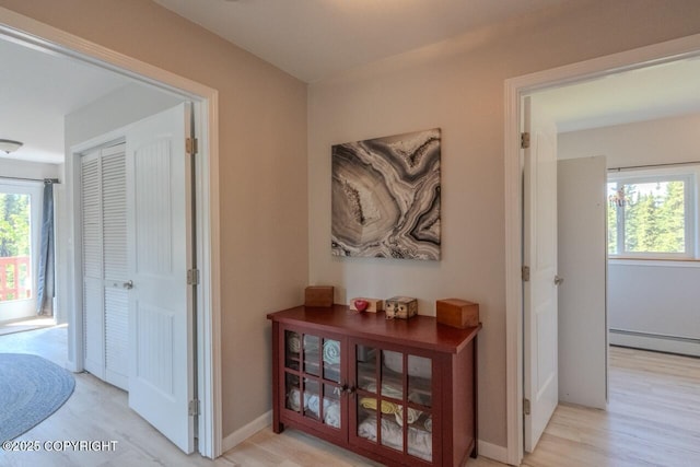 33426 Mid River Ave, Soldotna, AK 99669 - corridor featuring light wood-type flooring, plenty of natural light, and baseboard heating
