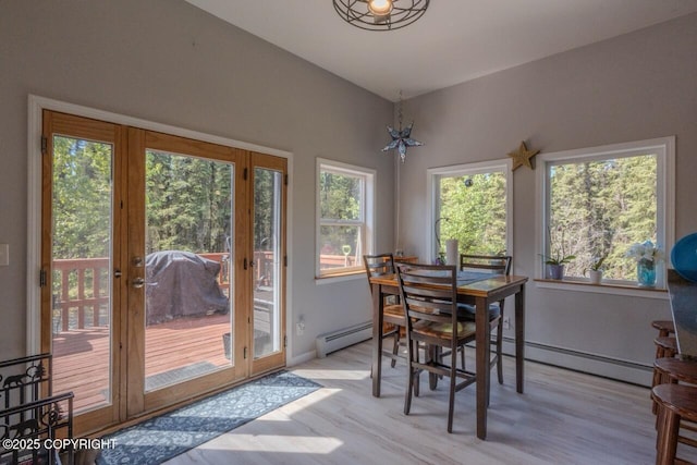 33426 Mid River Ave, Soldotna, AK 99669 - dining area with a baseboard heating unit, light wood-style flooring, french doors, and a chandelier
