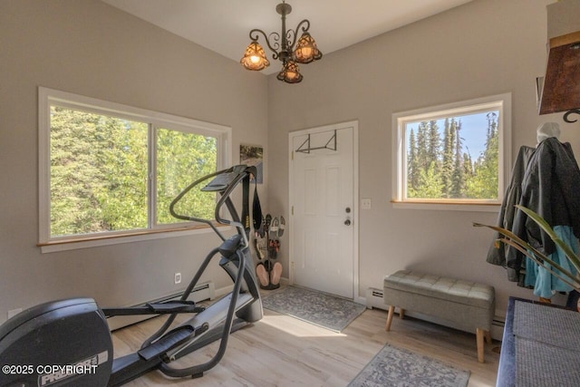 33426 Mid River Ave, Soldotna, AK 99669 - workout room with light wood-style floors, a chandelier, and a baseboard radiator