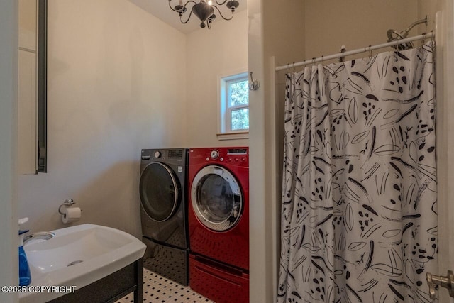 33426 Mid River Ave, Soldotna, AK 99669 - laundry area featuring washing machine and clothes dryer and a chandelier